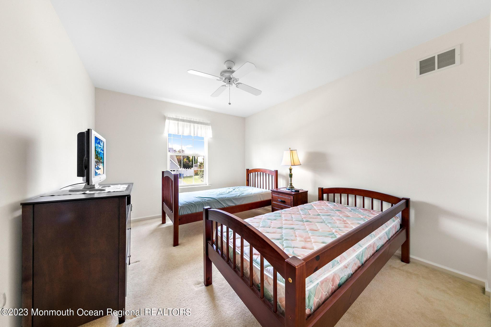 135 Barracuda Road Manahawkin, NJ 08050 - Photo 36 of 47 a bedroom with furniture and a table