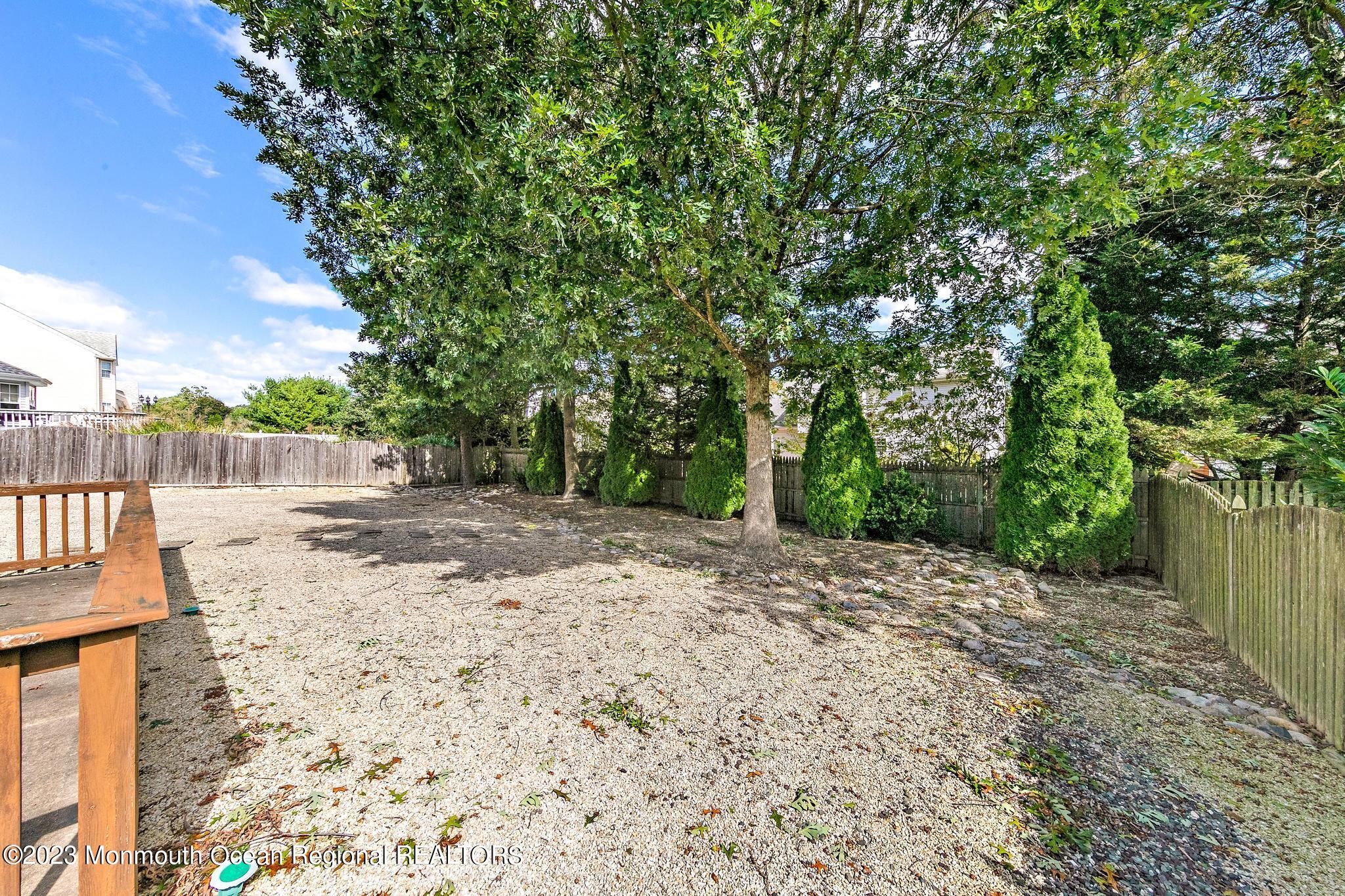 135 Barracuda Road Manahawkin, NJ 08050 - Photo 43 of 47 a view of a yard with plants and trees beside of it