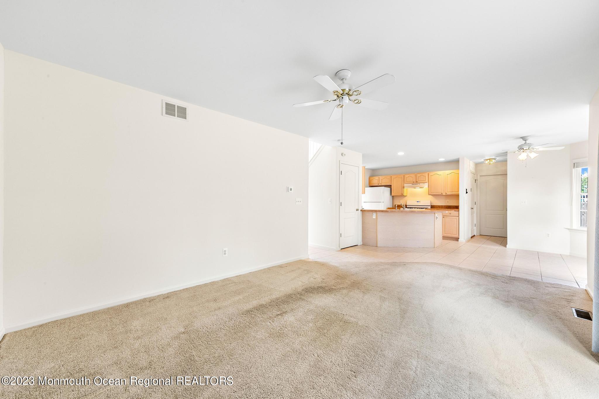 135 Barracuda Road Manahawkin, NJ 08050 - Photo 8 of 47 a view of a livingroom with a kitchen stove and a microwave