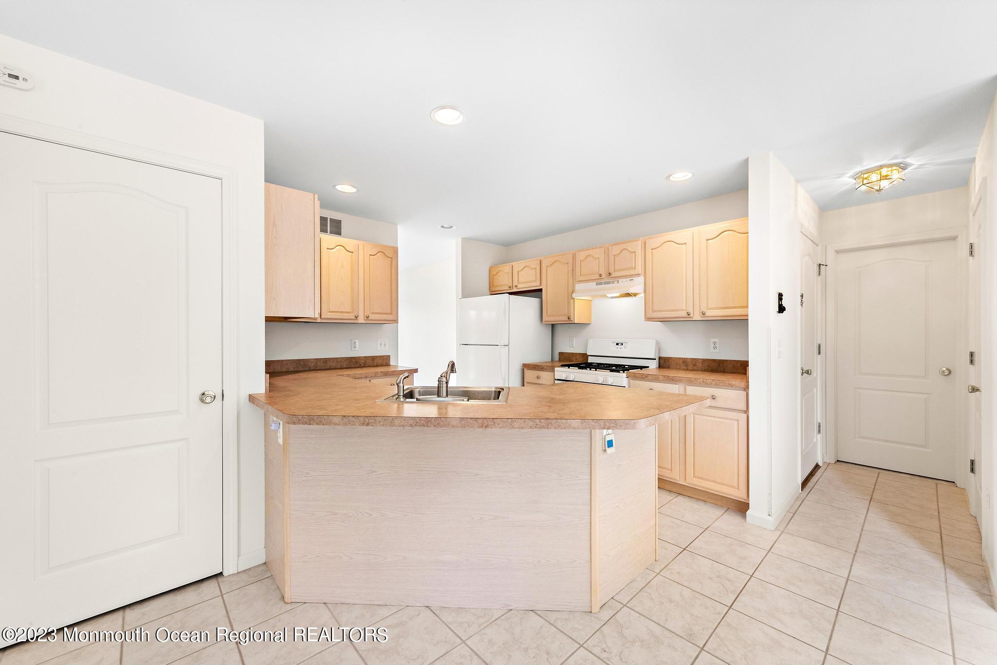 135 Barracuda Road Manahawkin, NJ 08050 - Photo 10 of 47 a kitchen with stainless steel appliances granite countertop a refrigerator and a sink