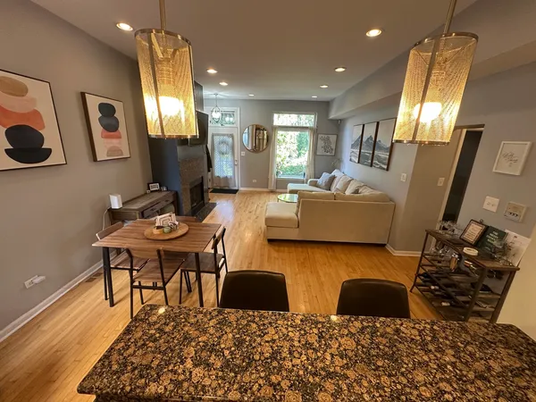 a living room with lots of furniture and a large mirror