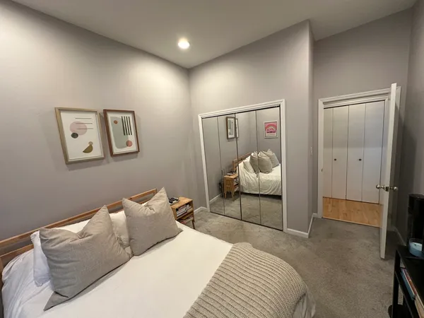 a bedroom with a bed and view of bathroom