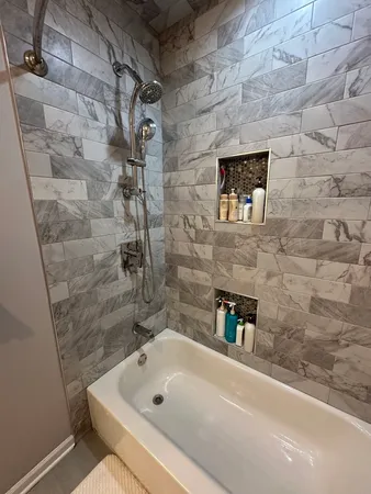 a bathroom with a tub and a shower
