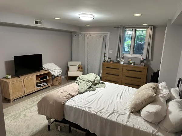 a bedroom with a bed and a flat screen tv