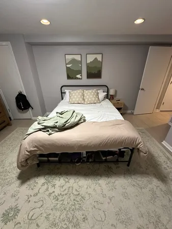 a bedroom with bed and a night stand