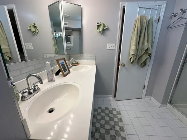 a bathroom with a sink a mirror and shower