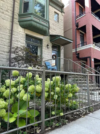 a front view of a house with a garden
