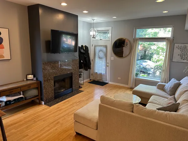 a living room with furniture a flat screen tv and a fireplace