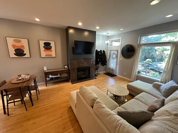 a living room with furniture a flat screen tv and a fireplace