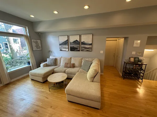 a living room with furniture and wooden floor