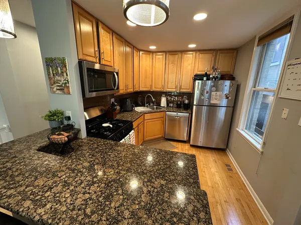 a kitchen with sink refrigerator and microwave