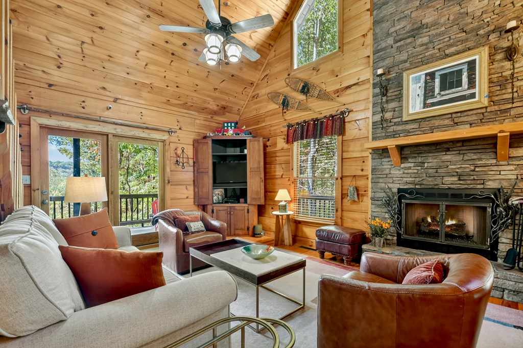 240 Lower Prince Mountain Road Cherry Log, GA 30522 - Photo 16 of 45 a living room with furniture a fireplace and a floor to ceiling window