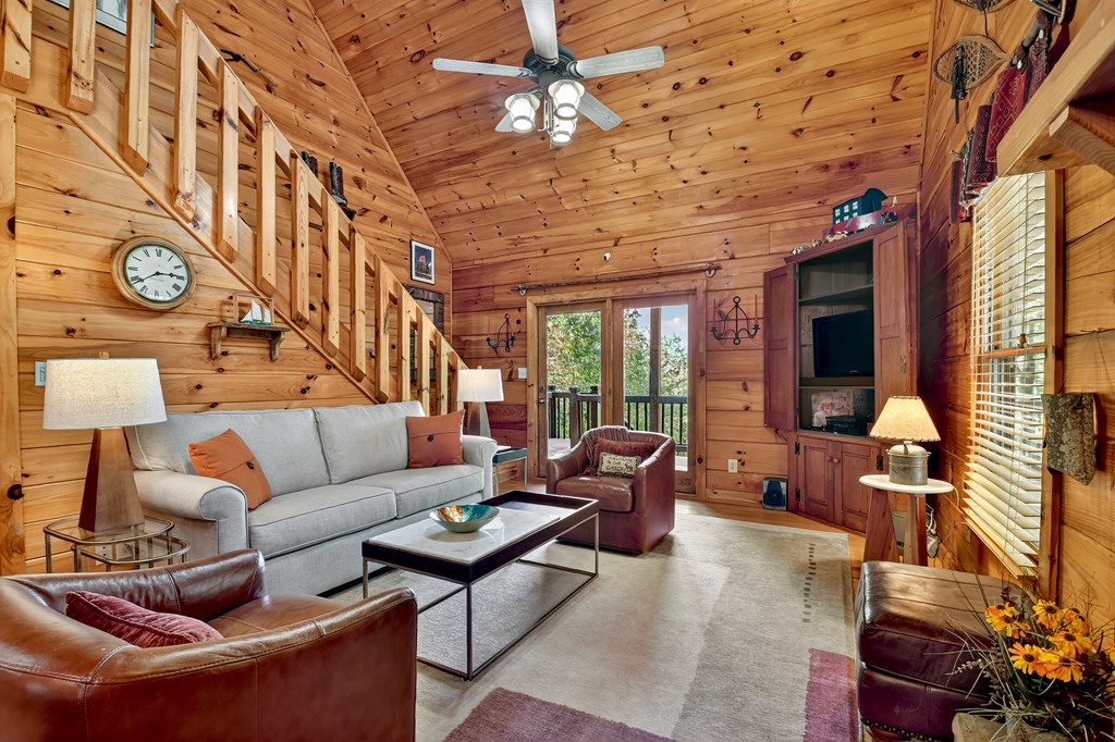 240 Lower Prince Mountain Road Cherry Log, GA 30522 - Photo 17 of 45 a living room with furniture a fireplace and a chandelier