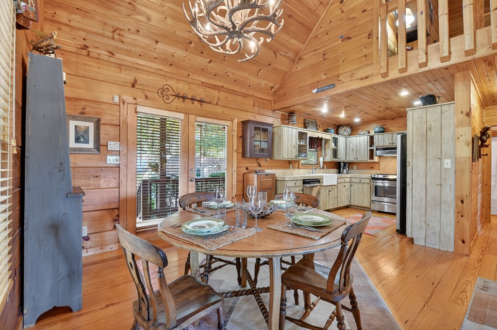 240 Lower Prince Mountain Road Cherry Log, GA 30522 - Photo 21 of 45 a dining room with stainless steel appliances kitchen island granite countertop a dining table and chairs