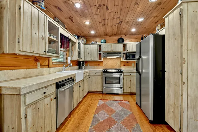 a kitchen with granite countertop a stove sink and cabinets