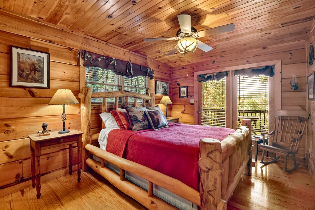 240 Lower Prince Mountain Road Cherry Log, GA 30522 - Photo 25 of 45 a bedroom with a bed and large windows