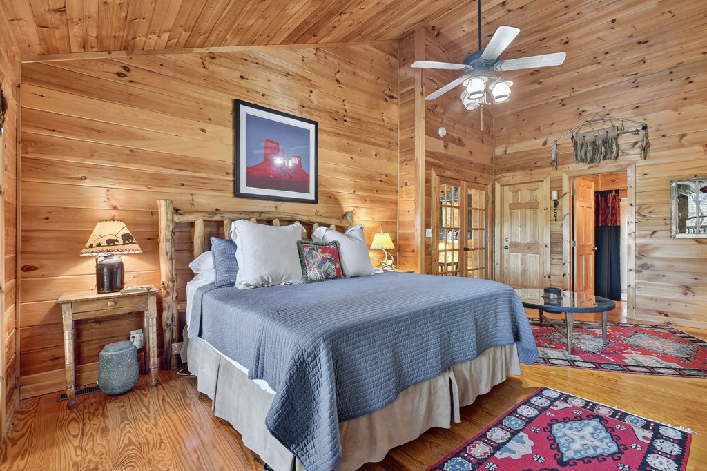 240 Lower Prince Mountain Road Cherry Log, GA 30522 - Photo 31 of 45 a bedroom with a bed and wooden floor