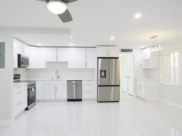 a kitchen with stainless steel appliances a refrigerator stove microwave and sink