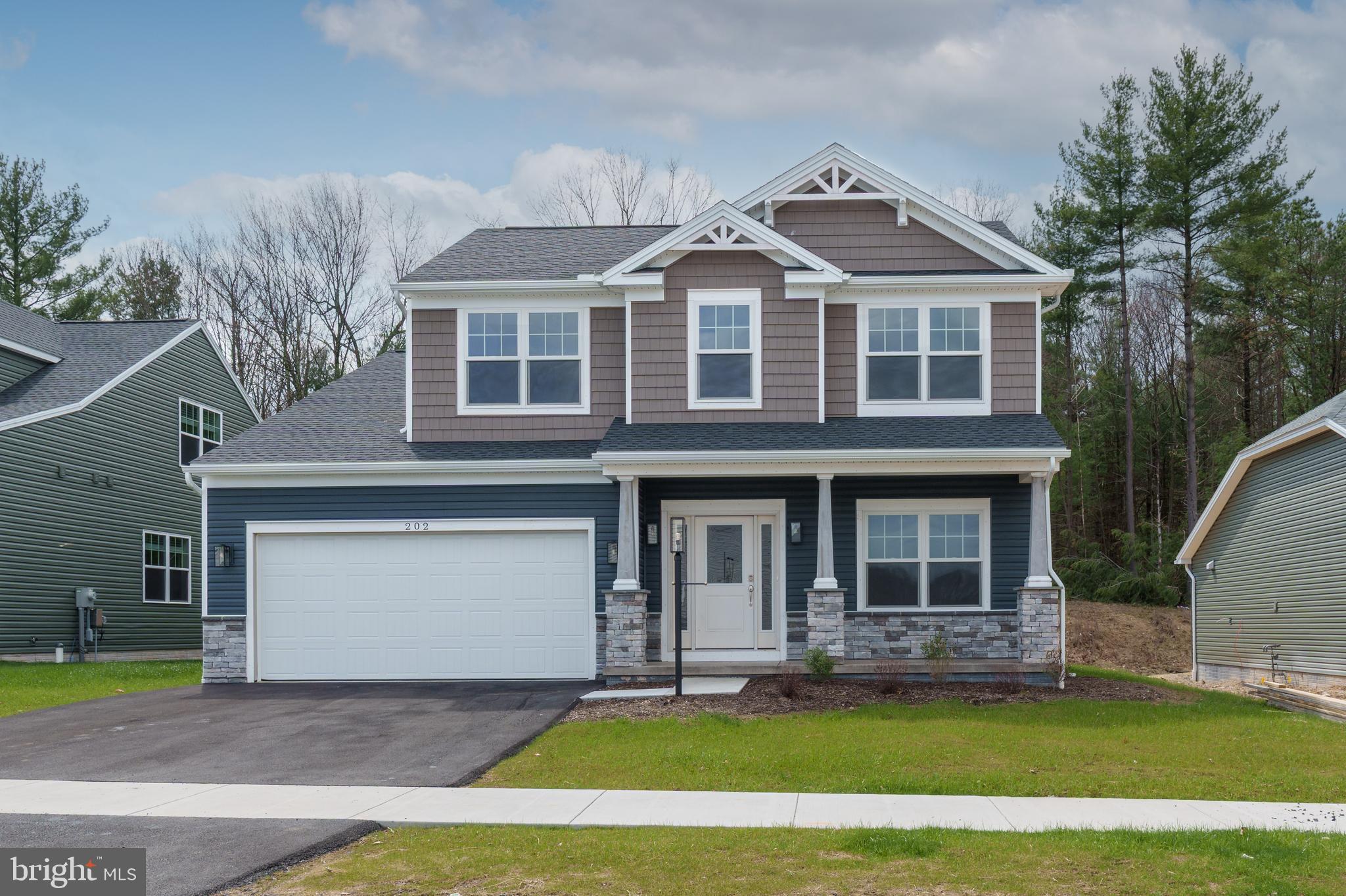 202 Phoebe Road Port Matilda, PA 16870 - Photo 1 of 52 a front view of a house with a yard and garage