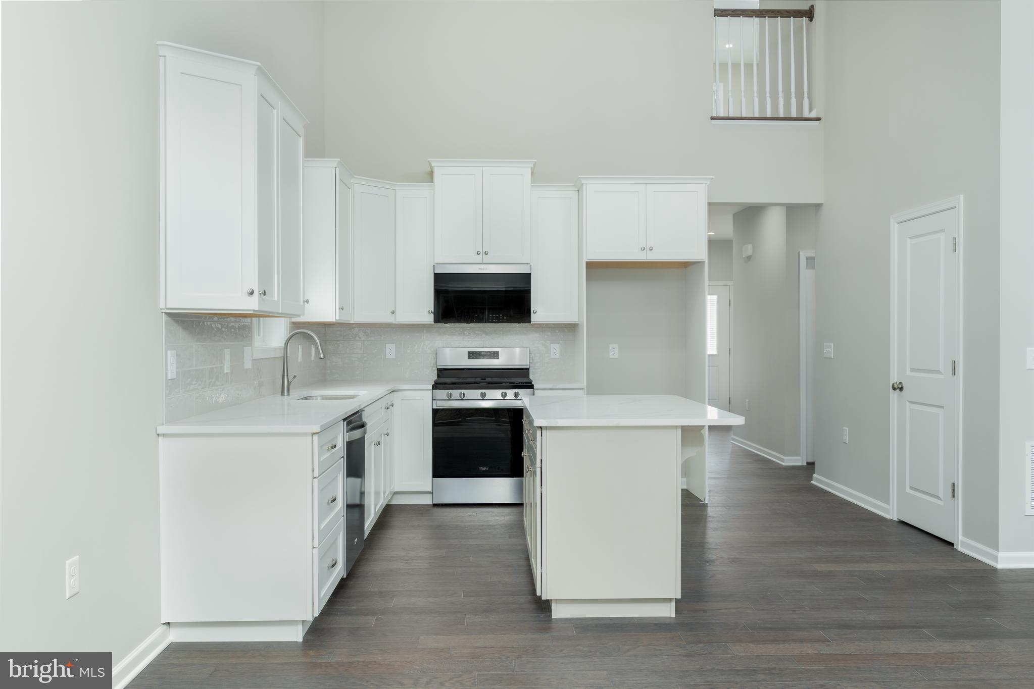 202 Phoebe Road Port Matilda, PA 16870 - Photo 18 of 52 a kitchen with stainless steel appliances a stove top oven a sink a refrigerator white cabinets and wooden floor