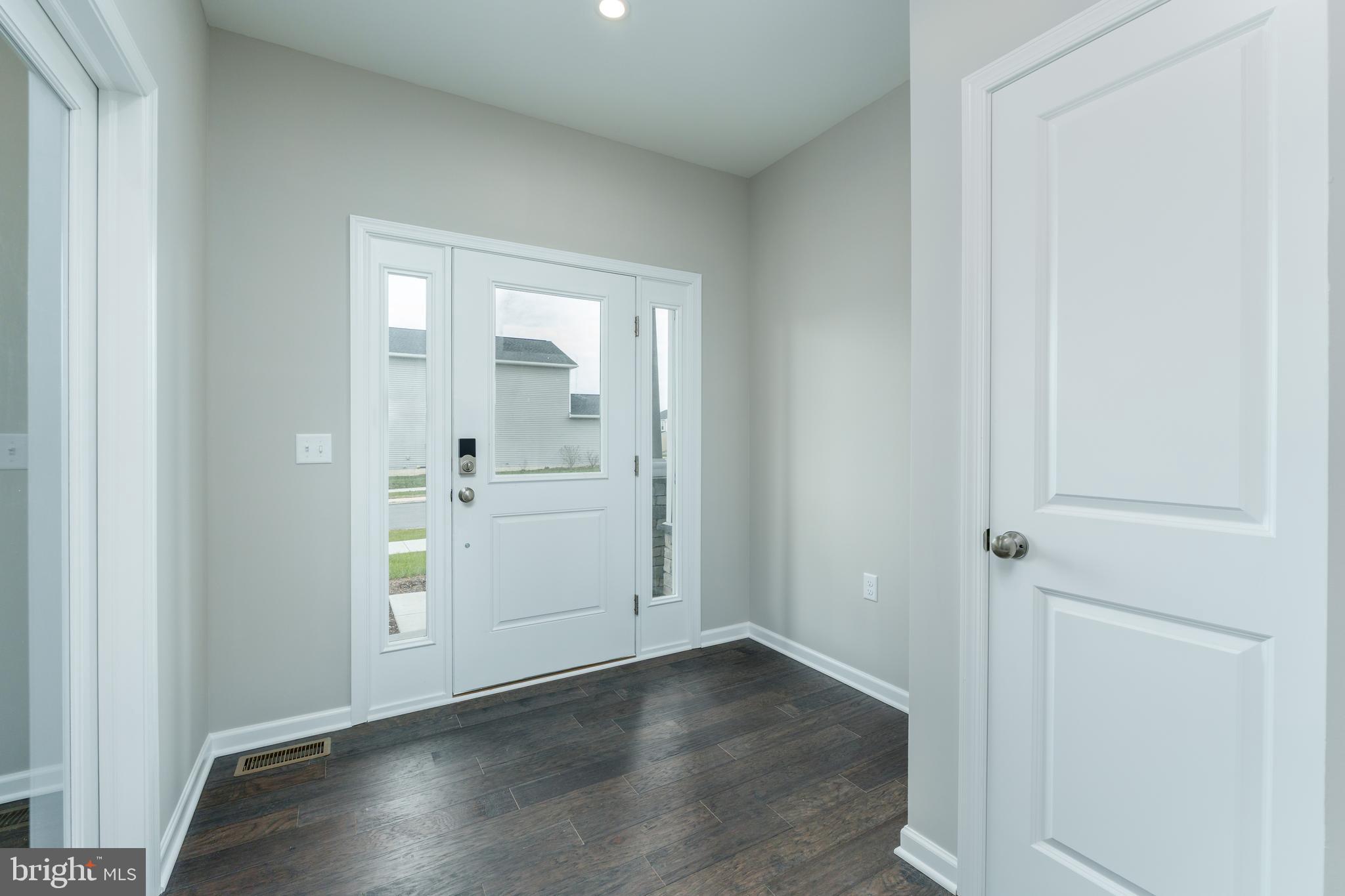 202 Phoebe Road Port Matilda, PA 16870 - Photo 2 of 52 an empty room with wooden floor cabinet and windows