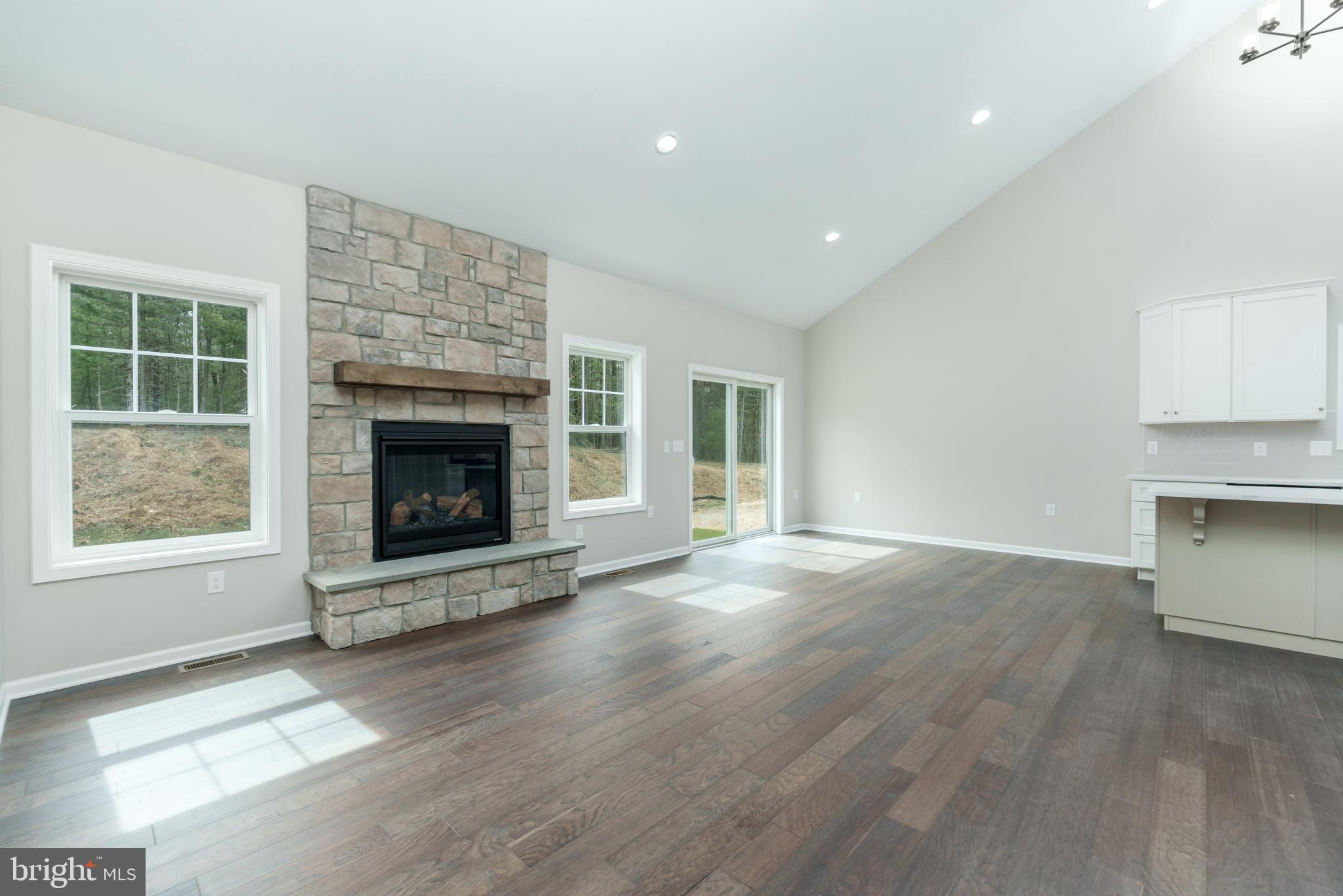 202 Phoebe Road Port Matilda, PA 16870 - Photo 23 of 52 a view of an empty room with a fireplace and a window