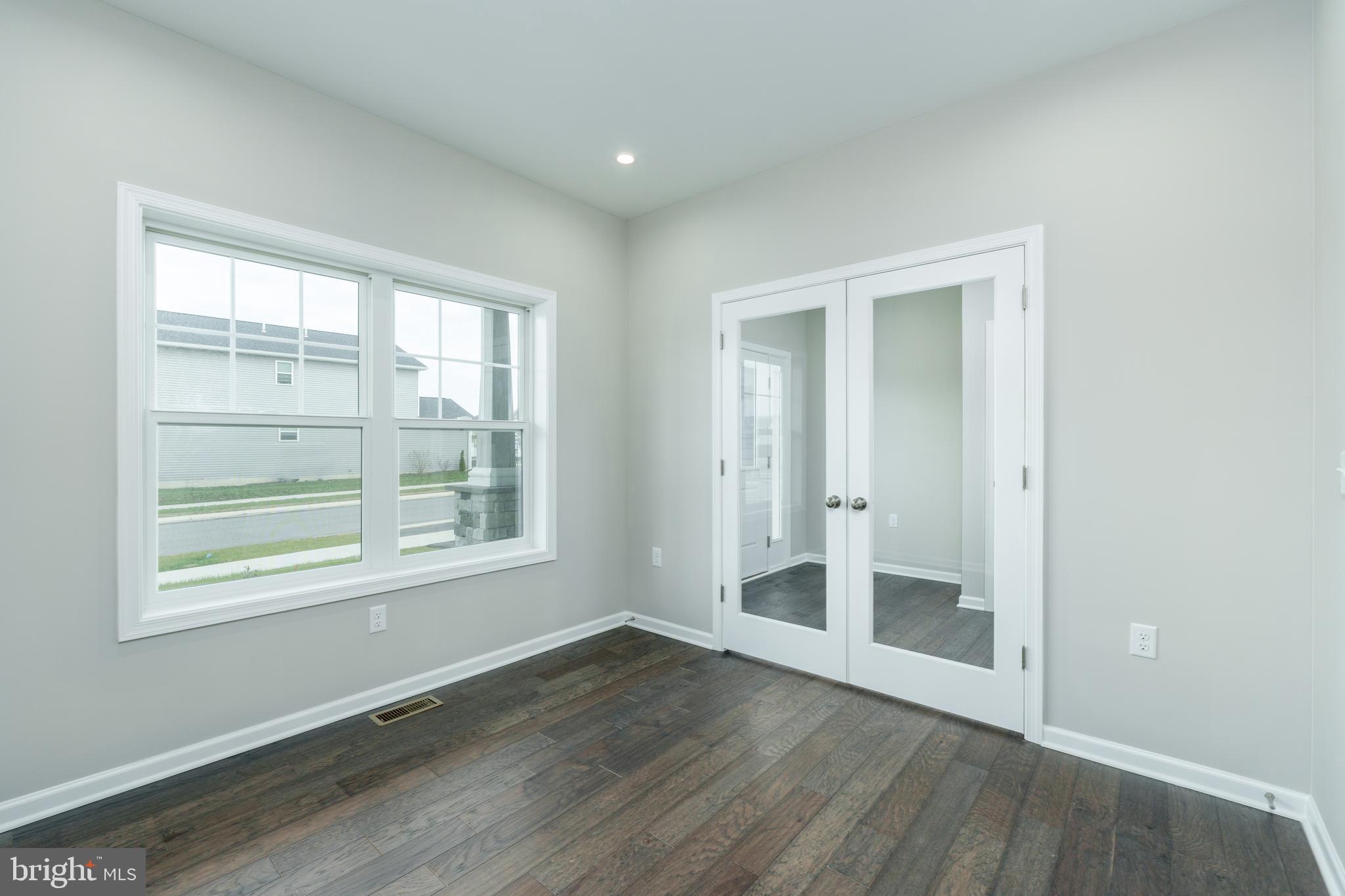 202 Phoebe Road Port Matilda, PA 16870 - Photo 6 of 52 an empty room with wooden floor and windows