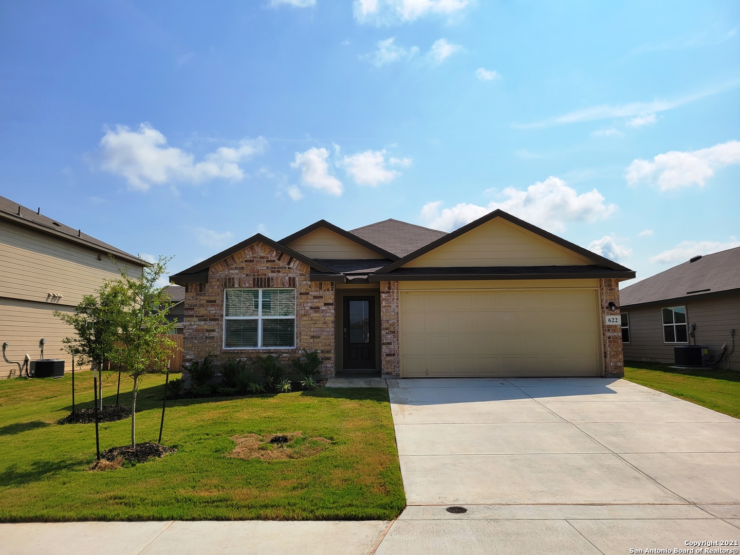 a front view of a house with a garden