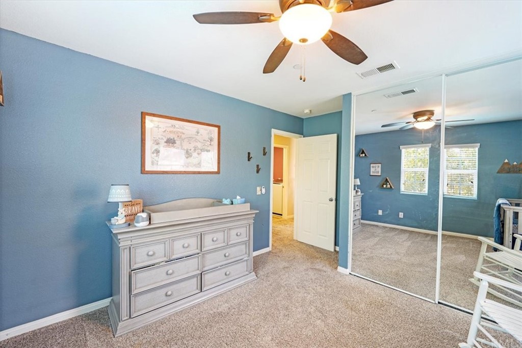 1777 Carrie Way Riverside, CA 92501 - Photo 13 of 35 a bedroom with a bed and a chandelier