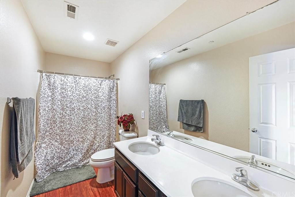 1777 Carrie Way Riverside, CA 92501 - Photo 15 of 35 a bathroom with a sink toilet and shower