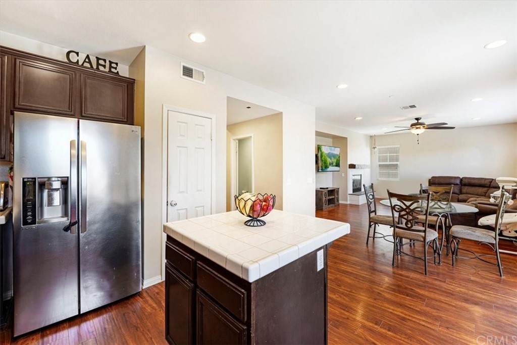 1777 Carrie Way Riverside, CA 92501 - Photo 23 of 35 a kitchen with a refrigerator and table chairs