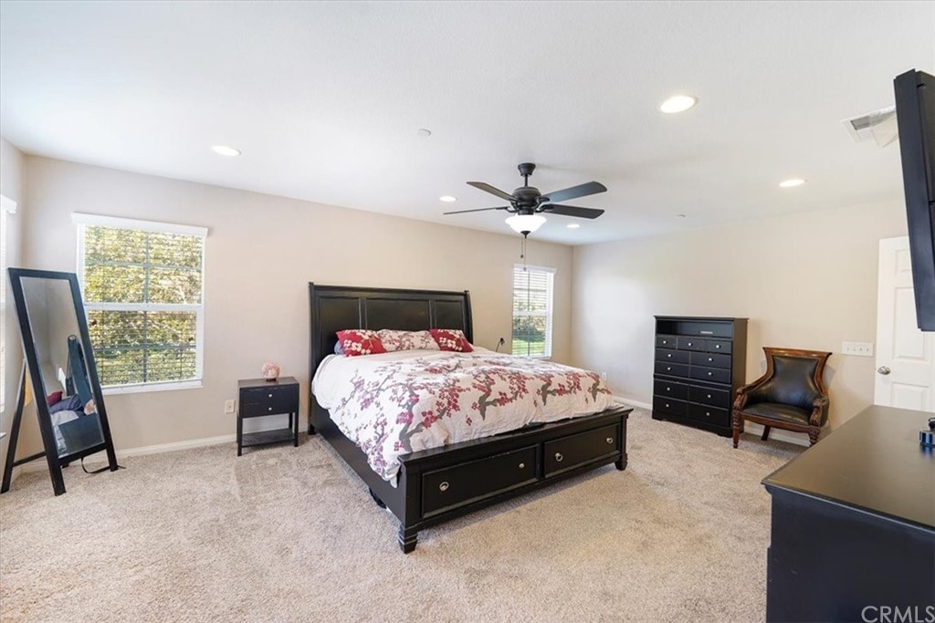 1777 Carrie Way Riverside, CA 92501 - Photo 26 of 35 a bedroom with a bed and a chandelier