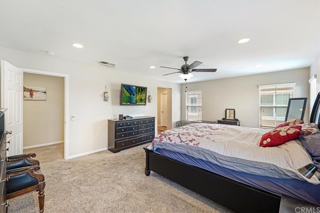 1777 Carrie Way Riverside, CA 92501 - Photo 28 of 35 a bedroom with a bed and a chandelier