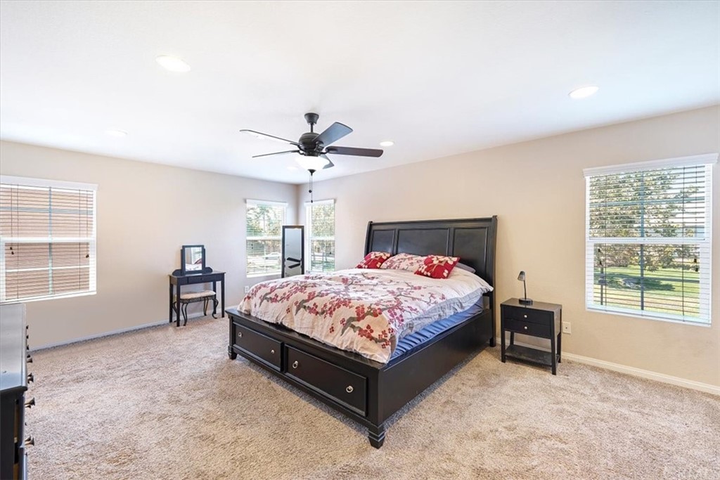 1777 Carrie Way Riverside, CA 92501 - Photo 7 of 35 a bedroom with a bed and a table lamp