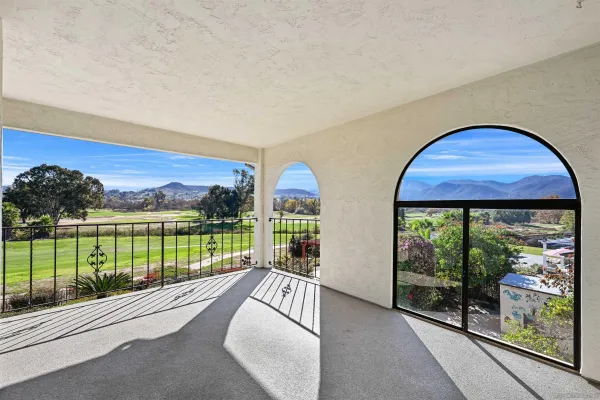 a view of a balcony with lake view and a floor to ceiling window