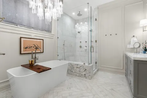 a bathroom with a tub sink and mirror