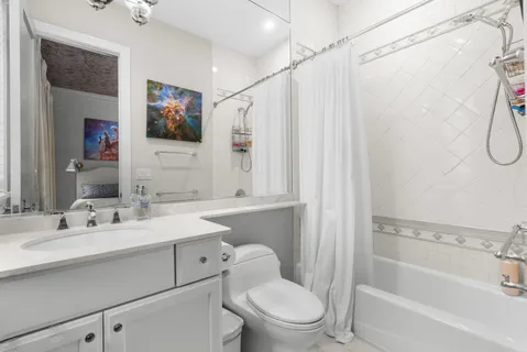 a bathroom with a sink toilet tub and shower