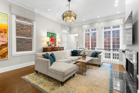 a living room with furniture and a chandelier
