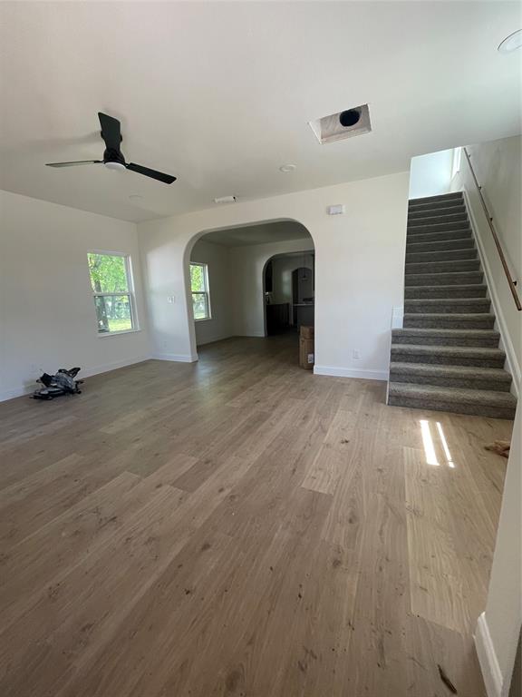 608 Ritchey Street Gainesville, TX 76240 - Photo 2 of 10 a view of a livingroom with wooden floor and stairs