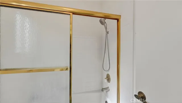 a bathroom with a granite countertop sink and bathtub