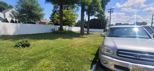 a view of a yard with chairs