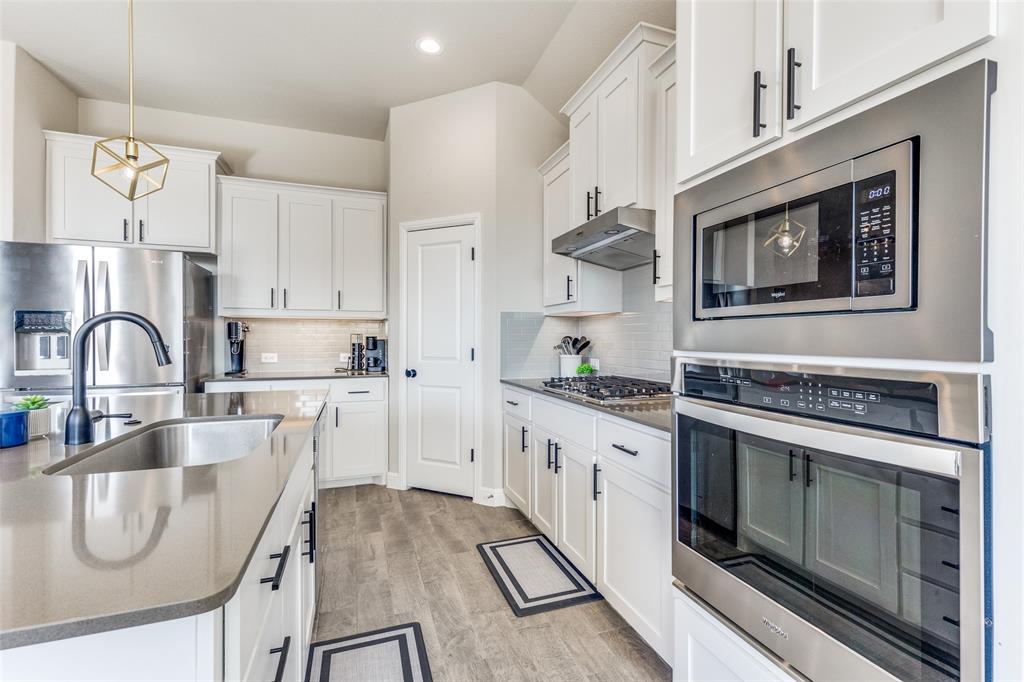1829 Bellatrix Drive Haslet, TX 76052 - Photo 11 of 25 a kitchen with granite countertop a stove and a sink