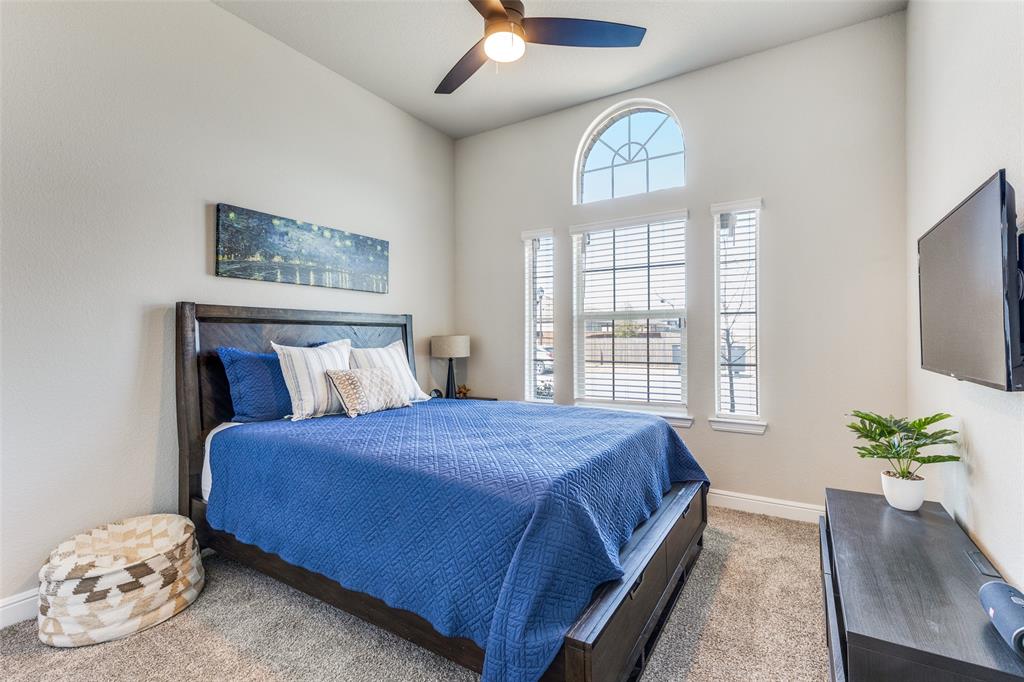1829 Bellatrix Drive Haslet, TX 76052 - Photo 19 of 25 a bedroom with a bed and a chandelier