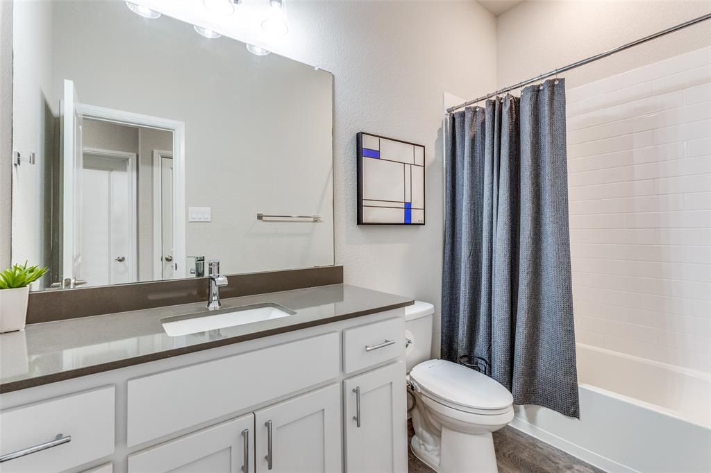 1829 Bellatrix Drive Haslet, TX 76052 - Photo 21 of 25 a bathroom with a granite countertop sink toilet and shower
