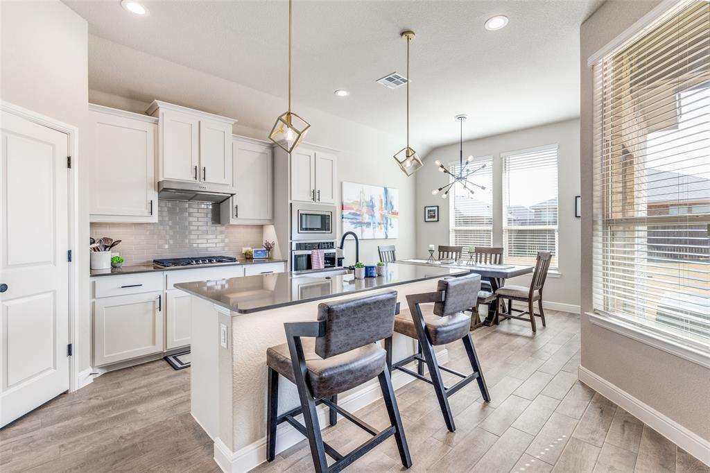 1829 Bellatrix Drive Haslet, TX 76052 - Photo 8 of 25 a kitchen with stainless steel appliances granite countertop counter space a sink and appliances