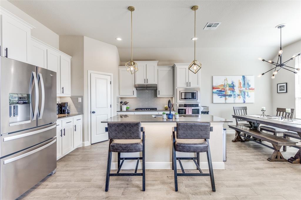 1829 Bellatrix Drive Haslet, TX 76052 - Photo 9 of 25 a kitchen with refrigerator cabinets and chairs