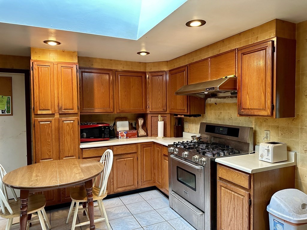 18 Seminole Road Dartmouth, MA 02748 - Photo 7 of 13 a kitchen with stainless steel appliances a stove a sink dishwasher and cabinets