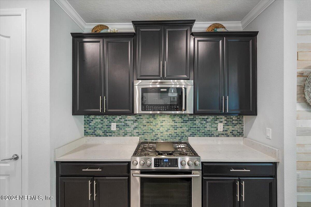 262 Clifton Bay Loop St. Johns, FL 32259 - Photo 11 of 57 a kitchen with a sink and stainless steel appliances