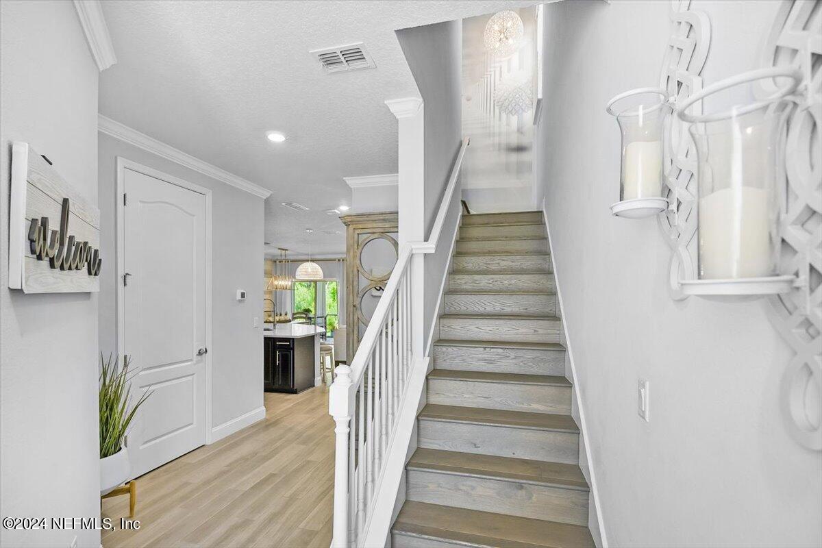 262 Clifton Bay Loop St. Johns, FL 32259 - Photo 16 of 57 a view of staircase with lots of frames and flower