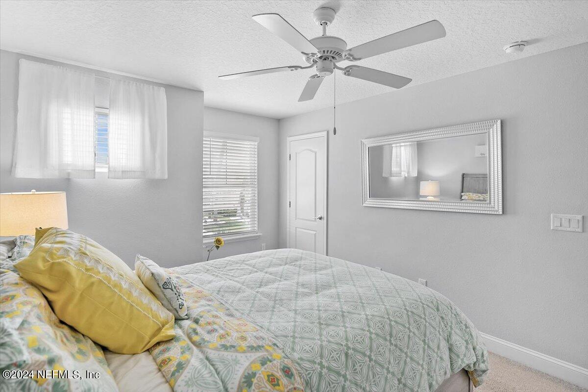 262 Clifton Bay Loop St. Johns, FL 32259 - Photo 23 of 57 a bedroom with a bed and wooden floor